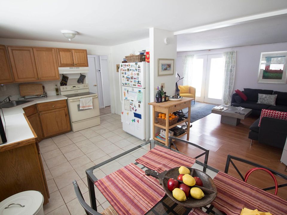 kitchen dining area and living room with access to the back 
