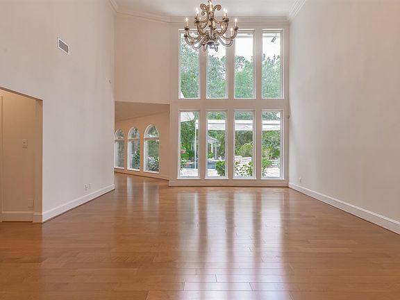 A wall of windows fill the two story living room with natural light.