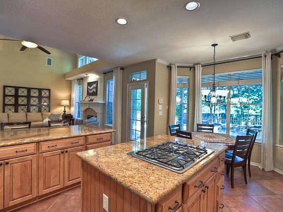 Island kitchen with gas cook top and open concept.