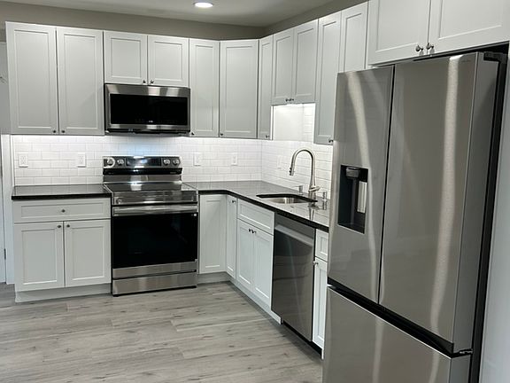 New range, new microwave, granite countertop, New flooring, Under-cabinet dimmable lighting.