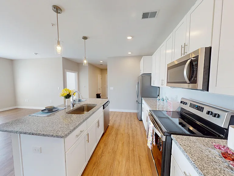 A kitchen that works hard and looks good, with granite countertops and stainless steel everything.
