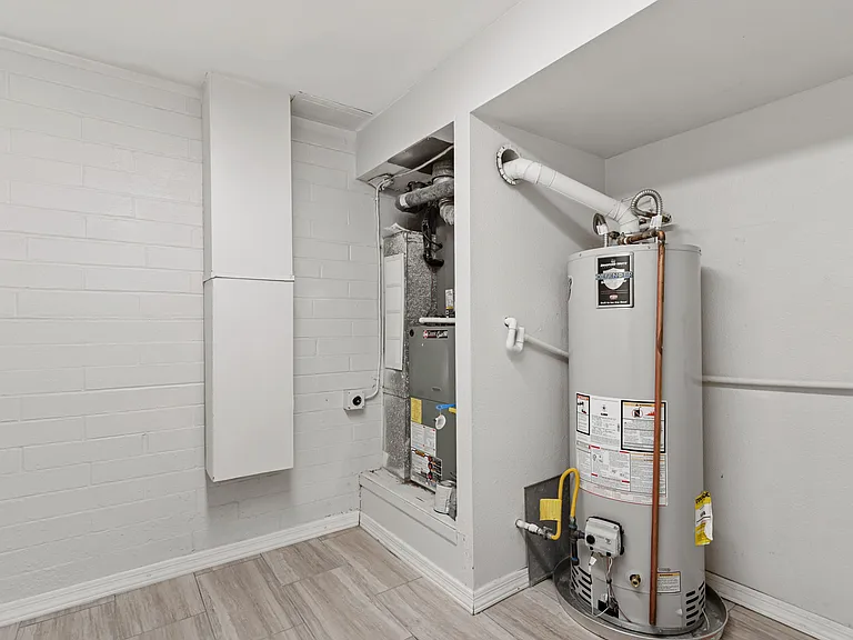 Utility area with water heater and extra storage keeps things organized.