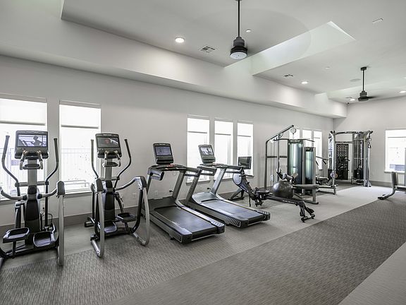 Fitness studio with spin bikes and cardio equipment.