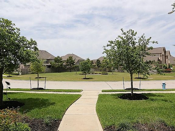 View from front door of home with wide open green space across the street.