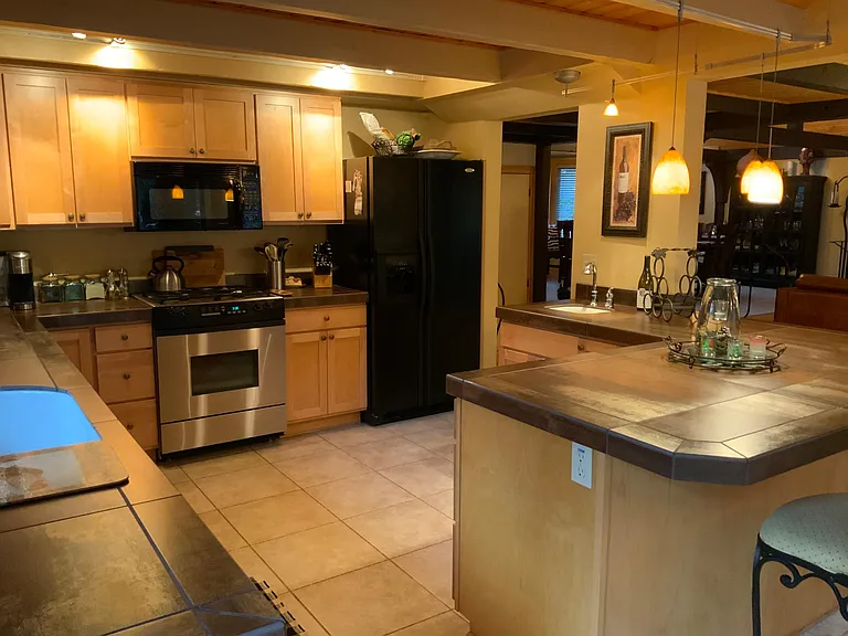 Gas cooking There is a new stainless refrigerator, stove and hood vent. There is a cabinet that will fit a microwave and planter of counter space for one if needed