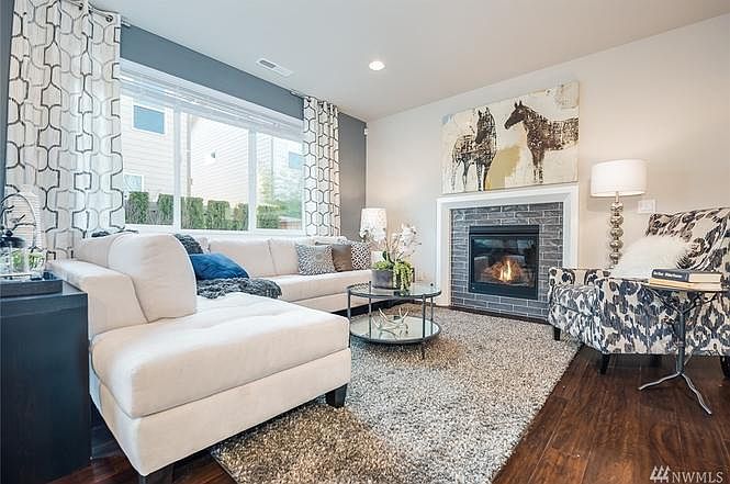 Living room and fireplace (picture from model home - same fl