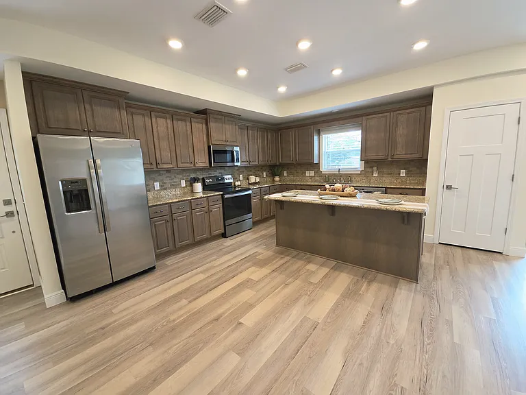 The kitchen sink has a window over it for natural lighting.
