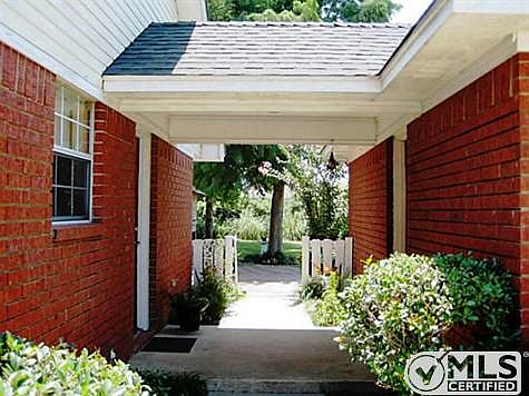 Breezeway opens up into the fenced backyard