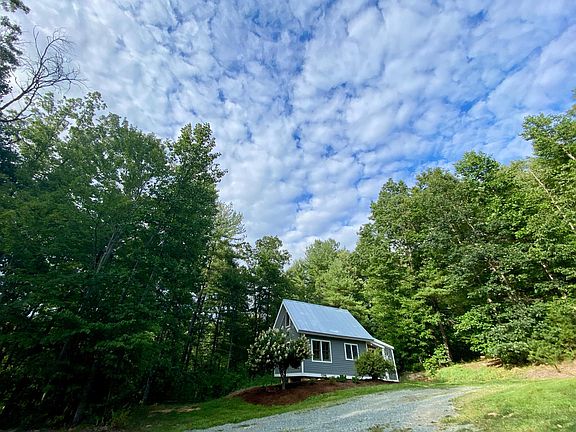 Cozy cottage nestled among the trees.
