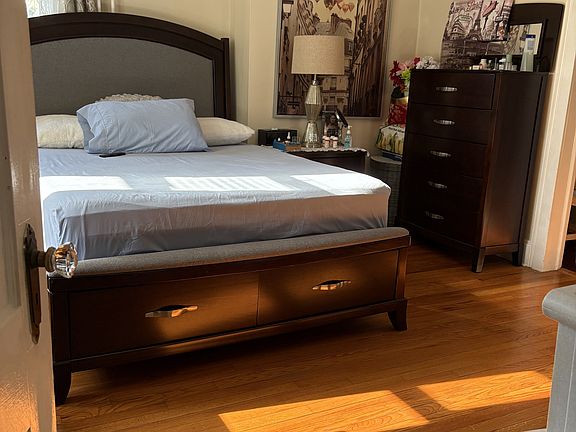 Primary bedroom gets wonderful sunlight, has wood floors and is very spacious