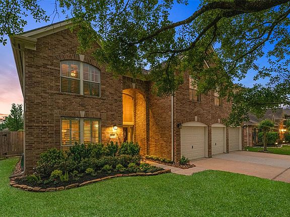 Beautiful brick exterior and lush landscaping provide fantastic curb appeal.