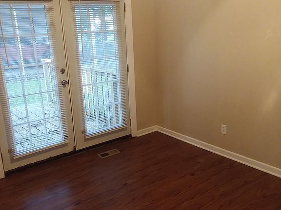 Center rear room with exit to a wood deck, Could be a bed room or study