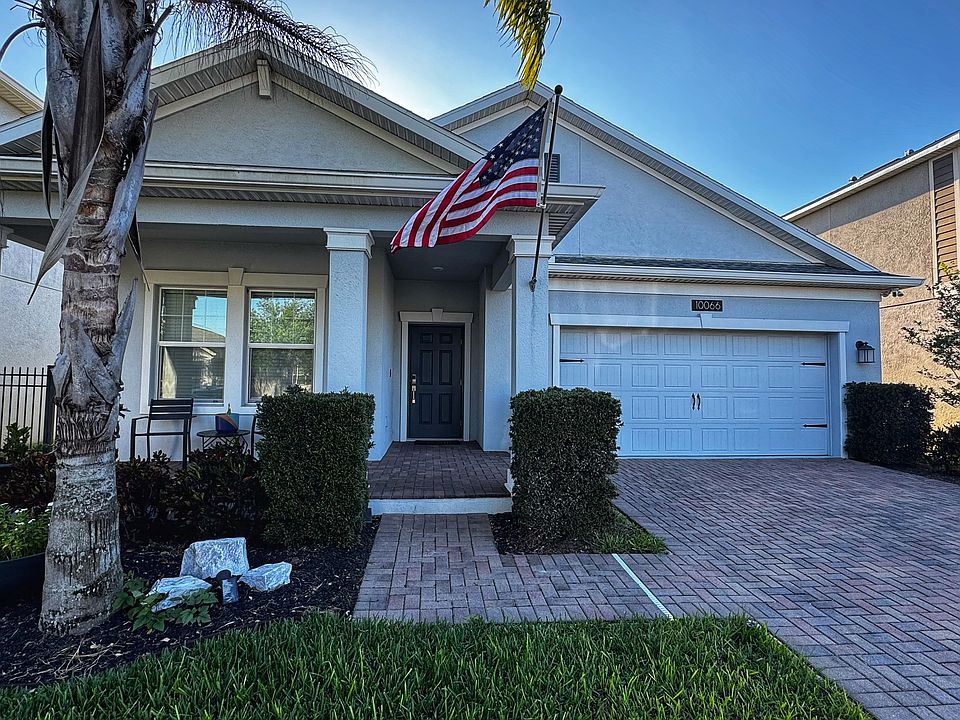 Front Exterior of Home _ Inviting curb appeal with paver driveway, and front yard landscaping.