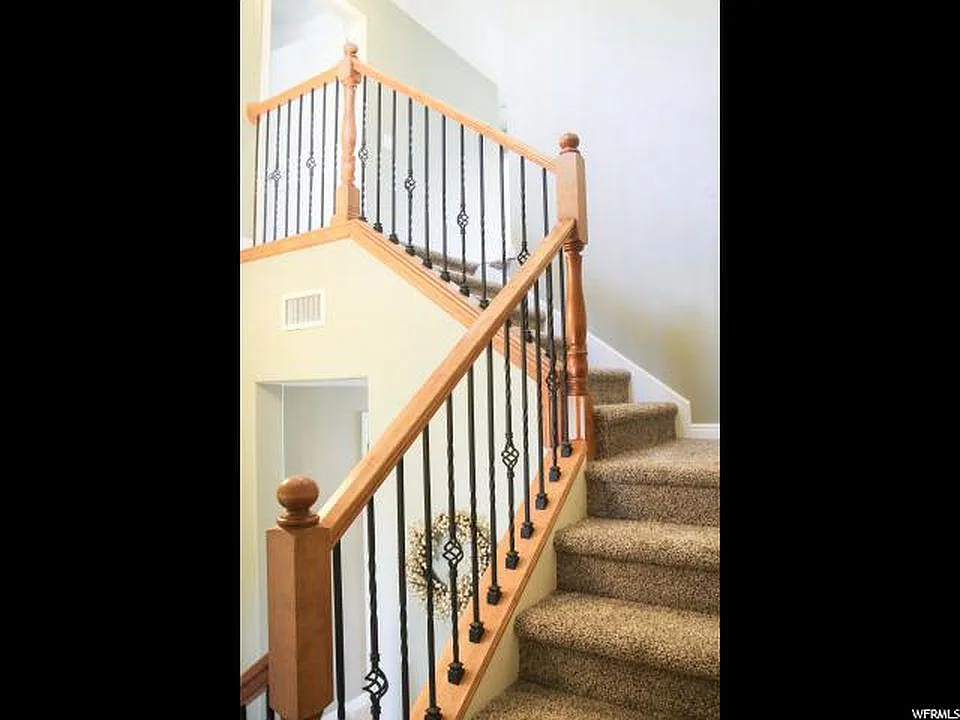 Beautiful open staircase leads to the upper floor bedrooms (