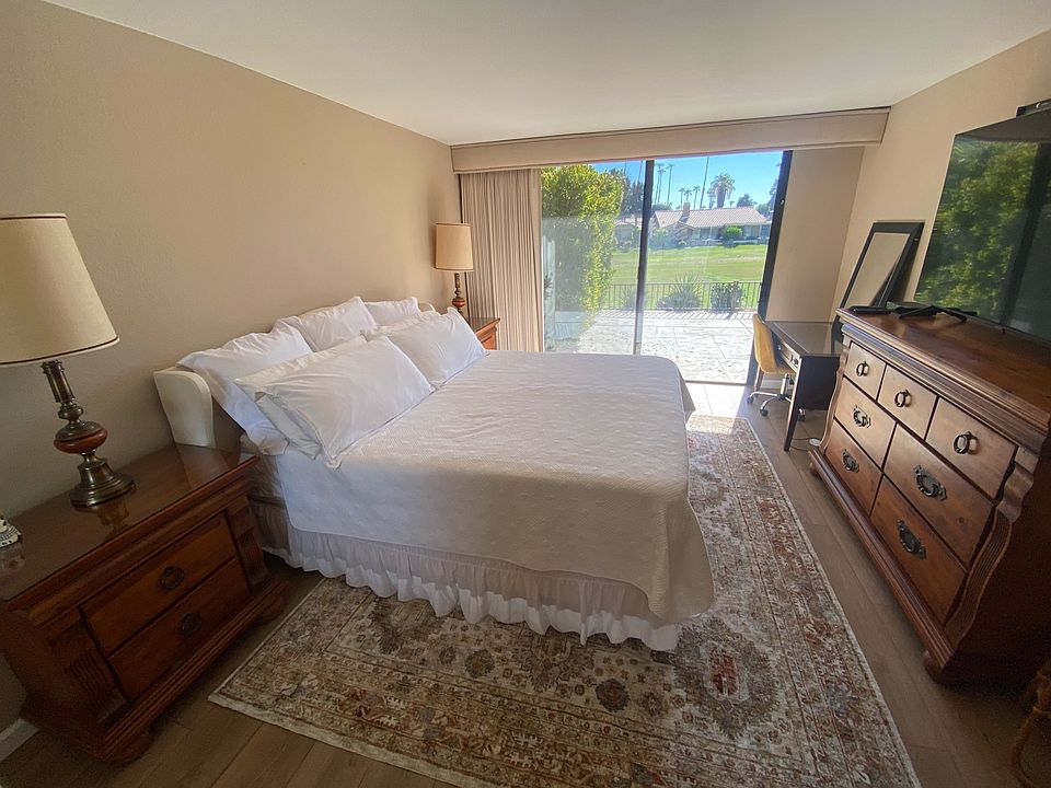 Primary bedroom with view to back patio and fairway.