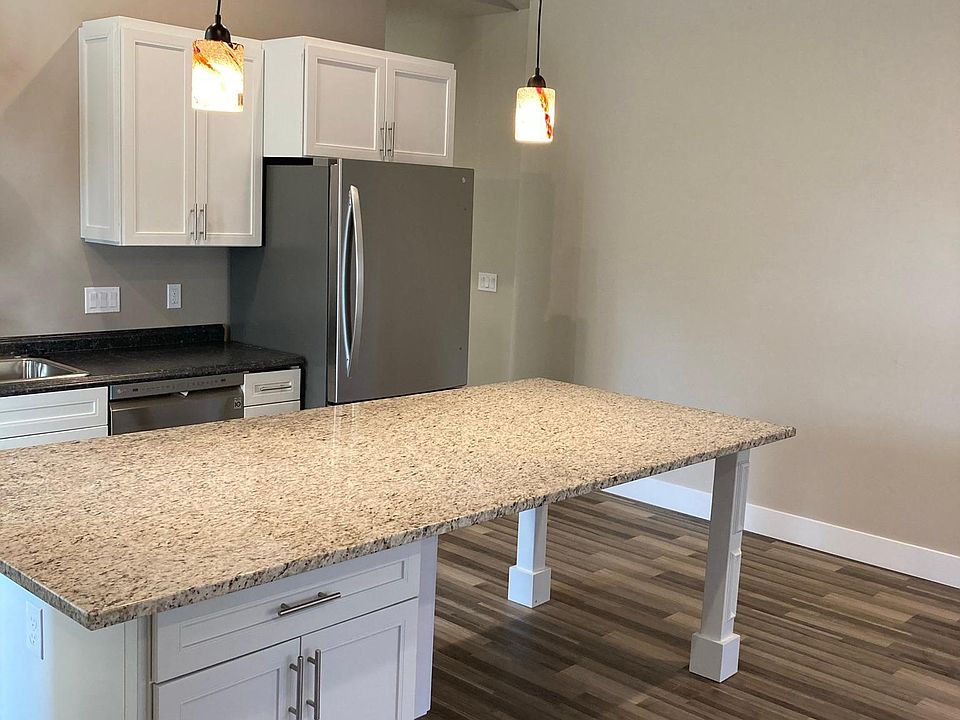 kitchen island with cabinets and large granite countertop