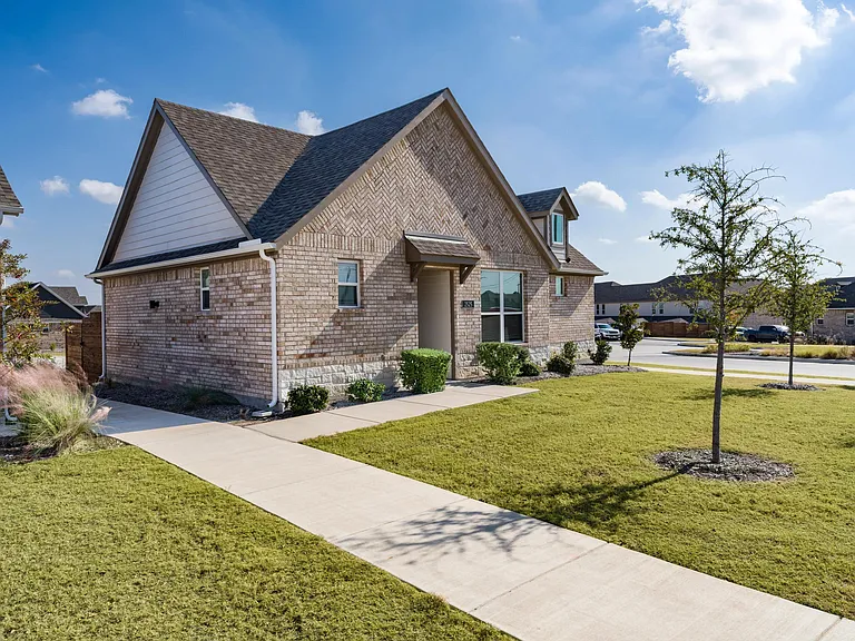 A thoughtfully designed single-family home at Amavi Celina with a private entry, landscaped yard, and a welcoming layout suited for everyday living.