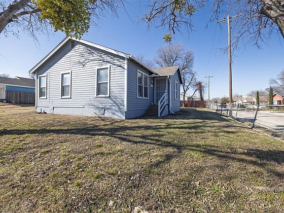 View of property exterior with a yard
