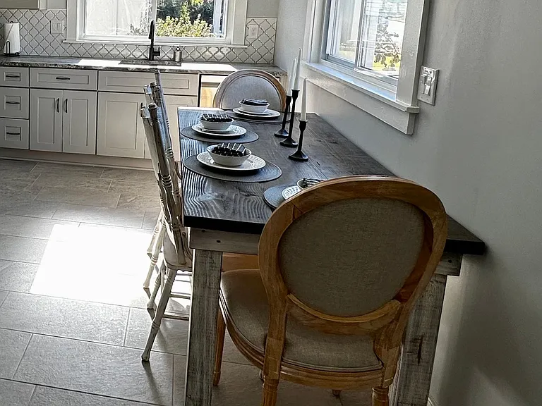 Eat-in kitchen with farm house table and settings for six