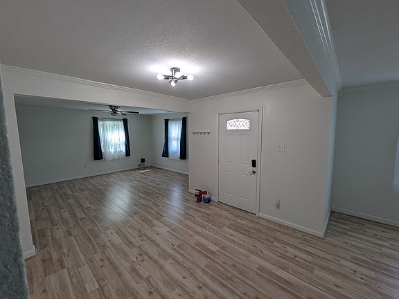 Entryway seen from the kitchen, looking into the living room.