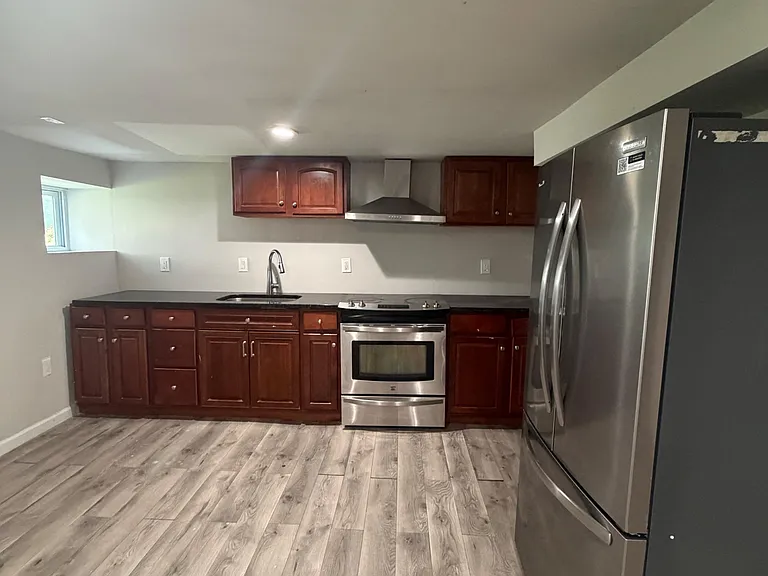 Full kitchen with ample cabinetry, generous counter space, and stainless steel appliances for everyday cooking.
