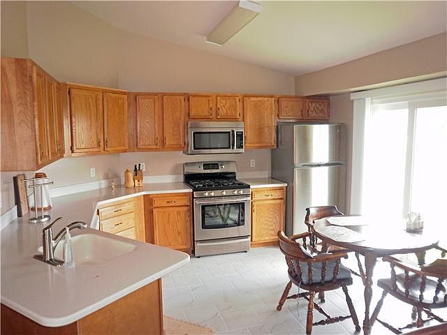 Corian counter tops, tile floor in kitchen