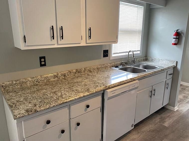 New Counter Top, Stainless Steel Sink, Brushed Nickel Faucet. New Dishwasher and Garbage Disposal. Freshly painted white cabinets with dark bronze hardware.