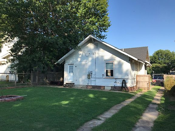 Fenced backyard with patio and firepit.