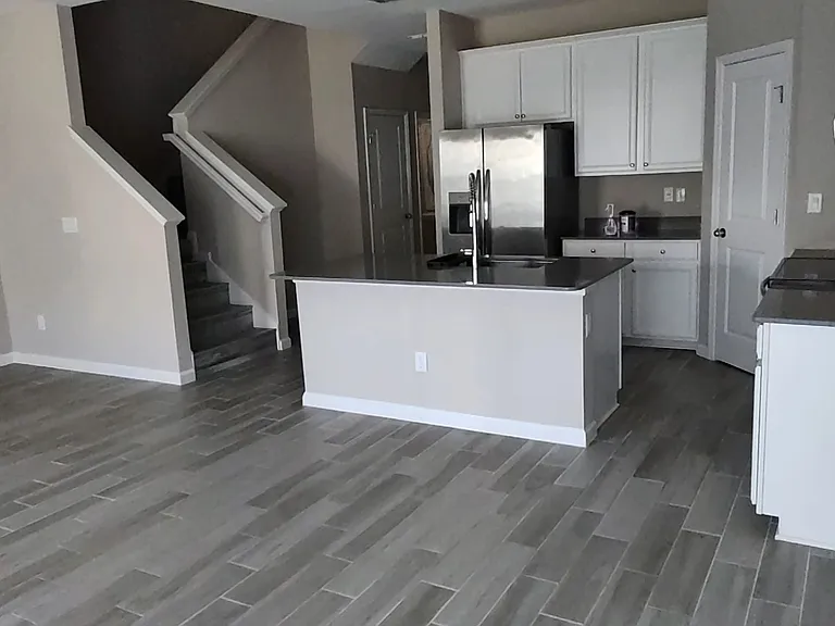 Great Room looking back to kitchen, stairs