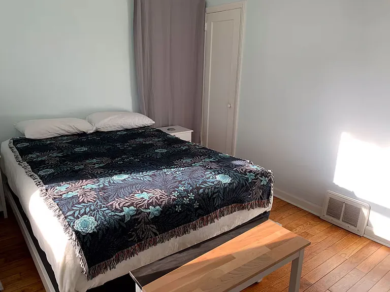 View of bedroom with shades open.