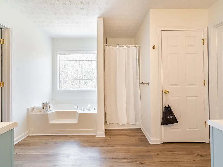 Large soaking bathtub and stand up shower.