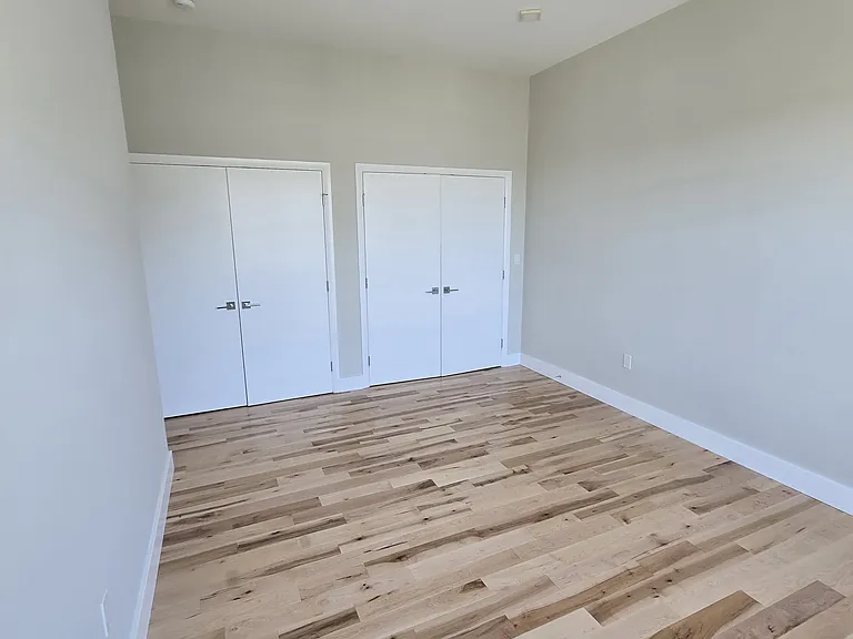 Primary bedroom with new wood floors (current photo).