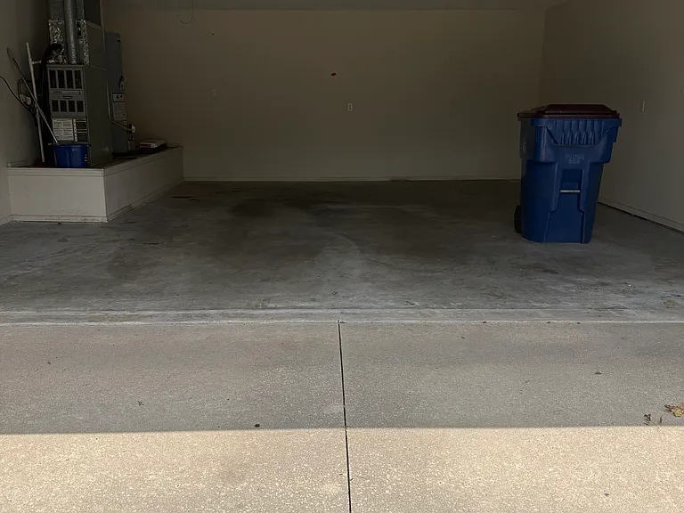 Double car garage with gas furnace and gas hot water heater and attic storage access.
