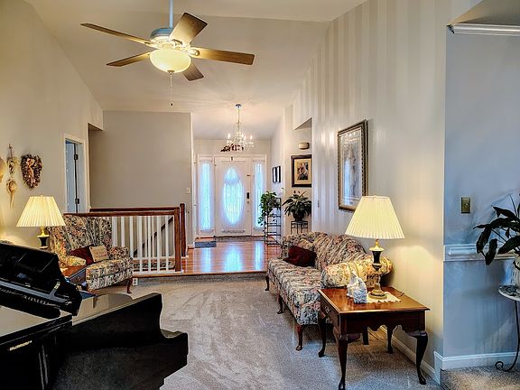 Looking toward the front door from the sunroom door. There's a good-sized sitting area with space at the end to use as you wish.