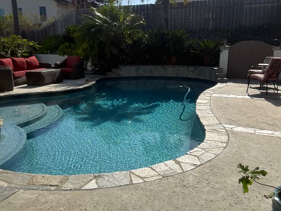 Pool showing Baja steps and bench around the spa