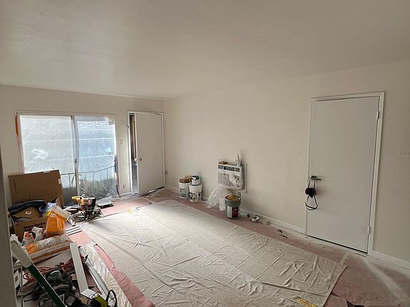 Completing renovation. Wood floors under the tarp. Paint is still drying.