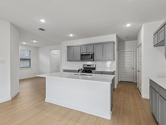 Kitchen in the Oak II home plan by Trophy Signature Homes - REPRESENTATIVE PHOTO