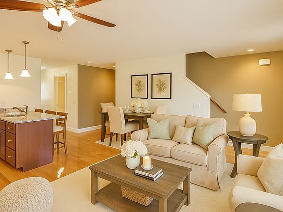 Oak wood floors, open layouts, and windows with curtain rods.