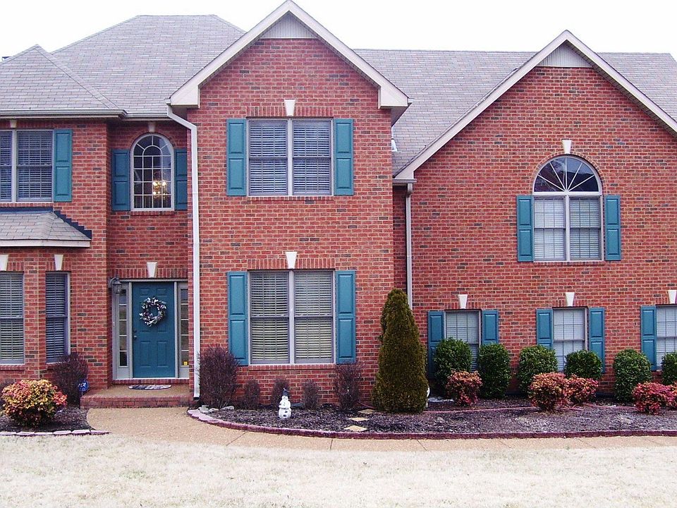 Three sides brick home on corner lot with aggregate drive and 3 car garage