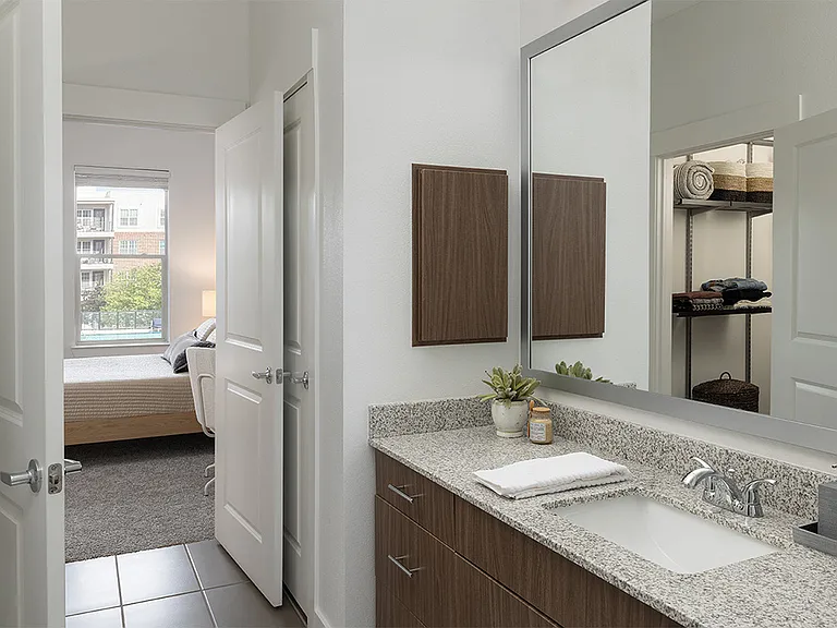 Apartment Bathroom with spacious closet and tile flooring.