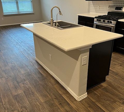 kitchen counter, faucet, and sink