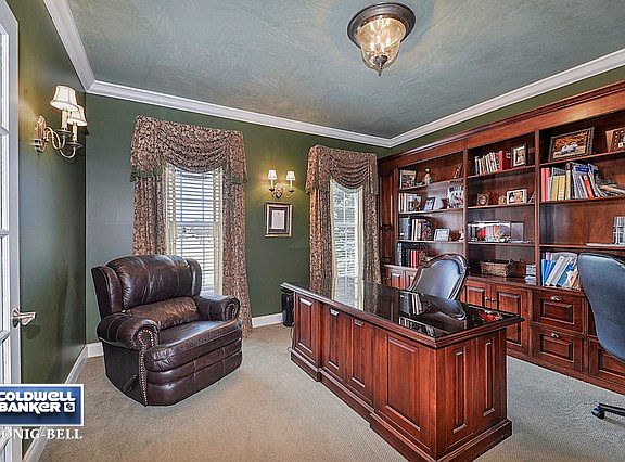 The Den features French Doors, Cherry Custom Built-in Shelving & Desk Unit, Crown Molding.