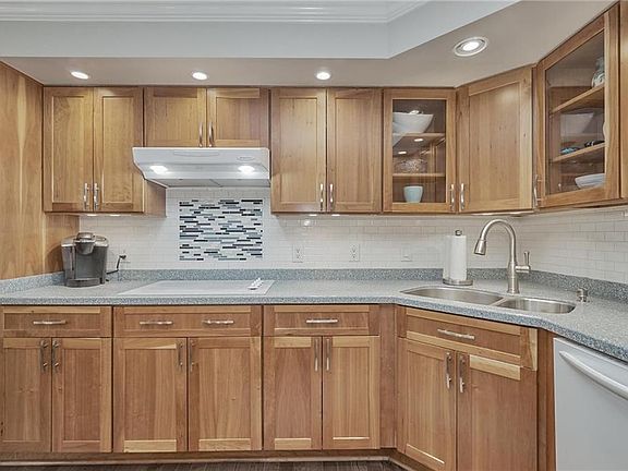 The Kitchen features Cherry, Shaker Style Cabinets with Soft Close Doors and Drawers and Custom Tile Backsplash