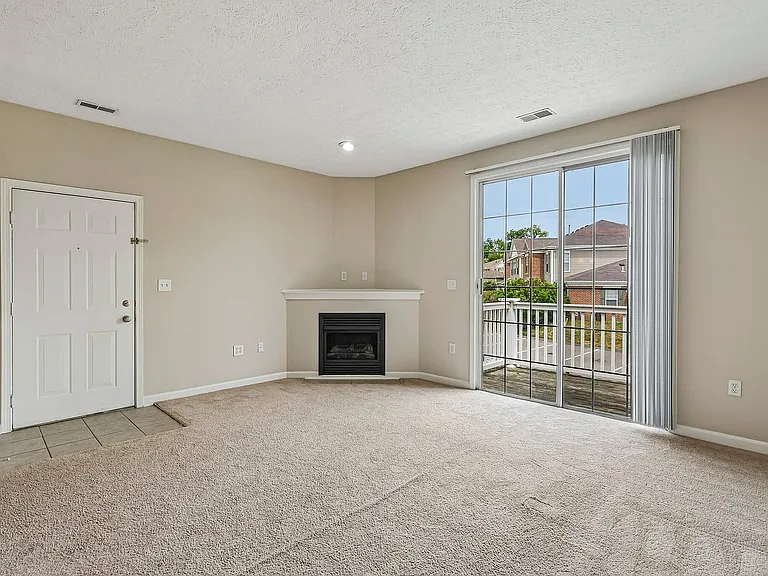 Bright and spacious living room with plush carpet