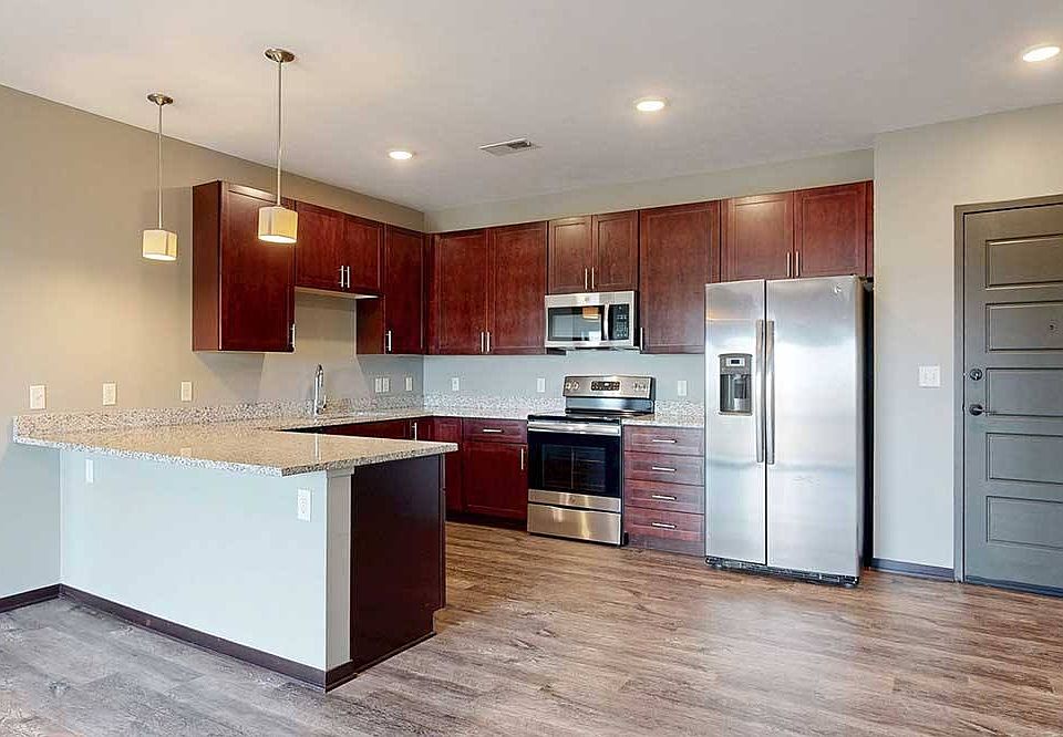Cook, gather, and entertain with ease in this spacious kitchen featuring modern finishes and a peninsula countertop.