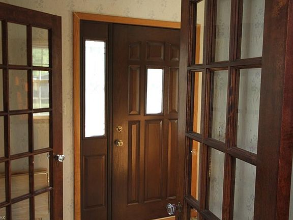 Original wood doors and french doors grace the entry.