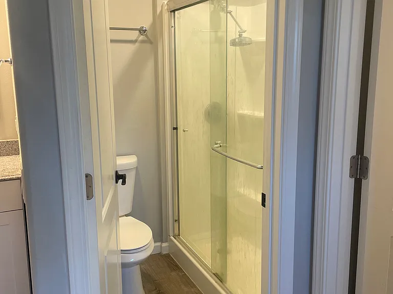 Walk in shower with glass doors.