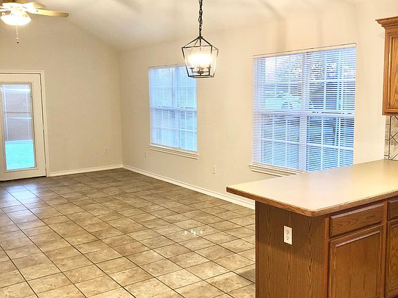 Open concept kitchen open to living room and breakfast area. French doors leading to the backyard. New mini blinds in living room.