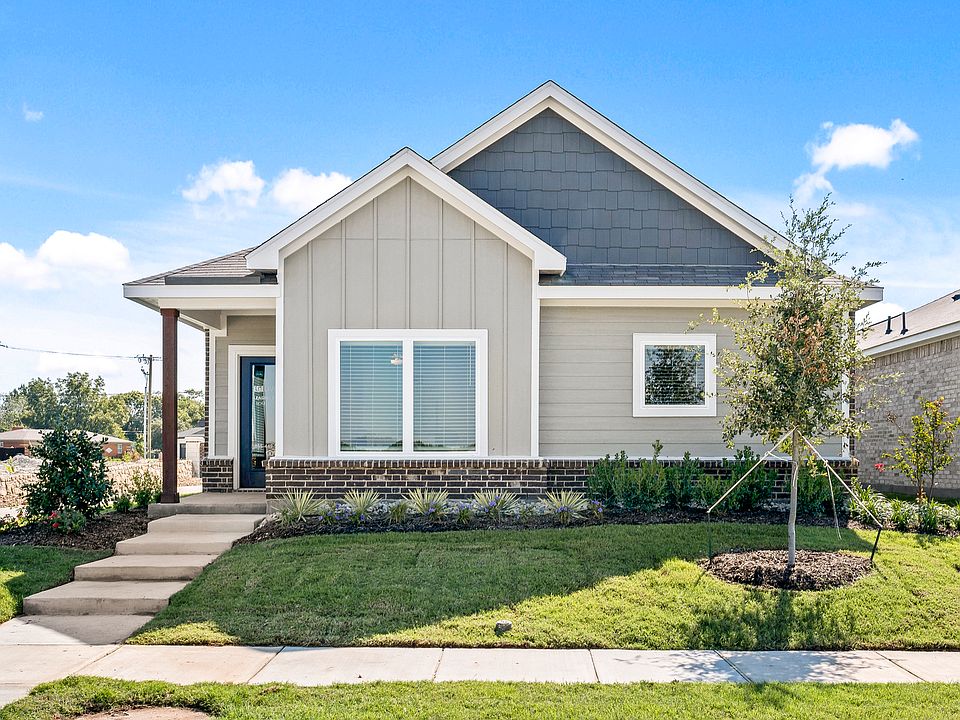 The Tulip is a beautiful one-story home with a siding exterior and brick accents.