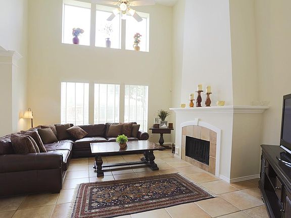 FAMILY ROOM (19 X 16)... Two story ceiling heights, wall of windows overlooking backyard, fireplace with gas connection and traditional mantel.